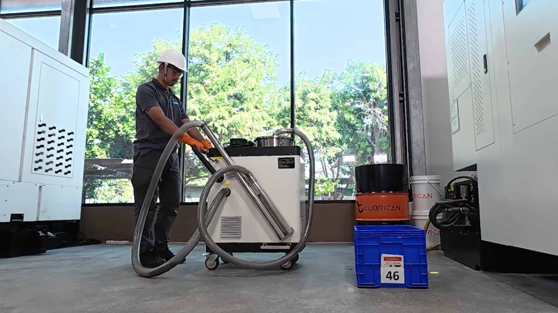 Factory staff operating LUBRICAN CFR for coolant fluid maintenance and machine cleaning