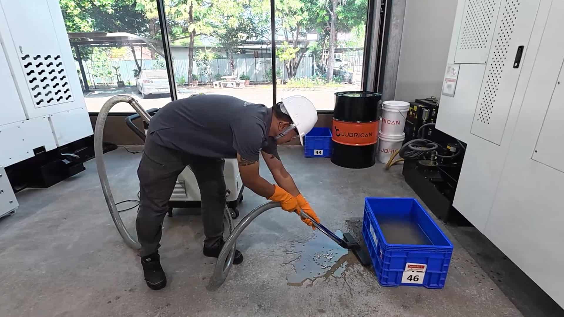 Using LUBRICAN CFR multi-purpose vacuum to clean up oil spills on factory floor for 5S standards