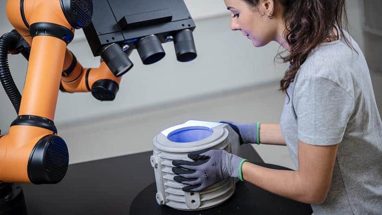 Operator positioning casting part on ZEISS ScanCobot rotation table for automated 3D scan quality control by Factory Max