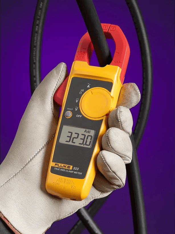 Fluke 323 True-RMS Clamp Meter in use clamping an electrical wire for safety testing